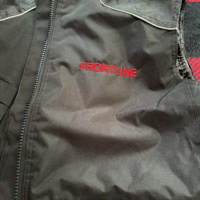 Black custom embroidered workwear bodywarmer with red Frontline logo embroidery on the left chest by KMVT Workwear