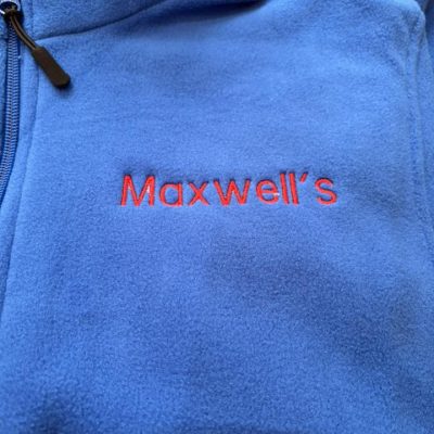 Royal blue embroidered fleece jacket with Maxwell’s logo stitched in red on the left chest by KMVT Workwear